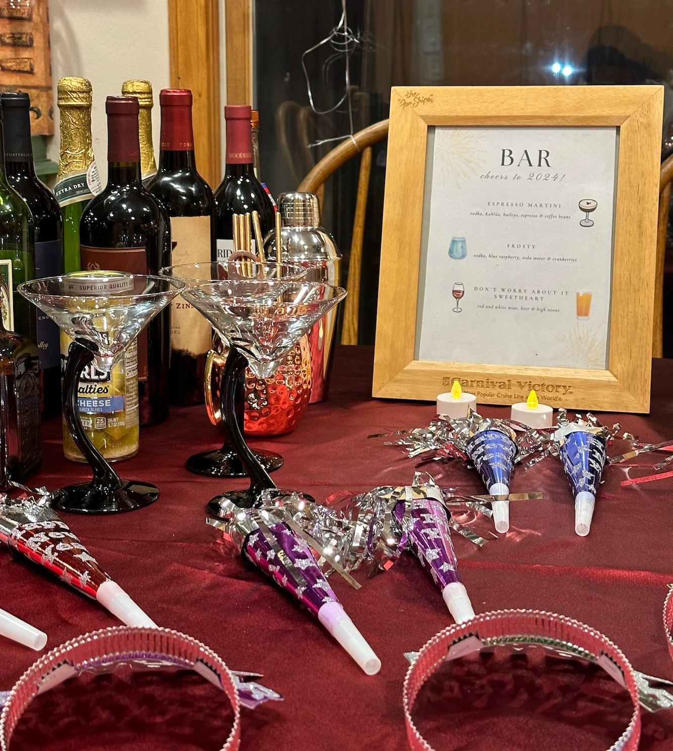 Event bar setup with cocktails, menu, and party favors